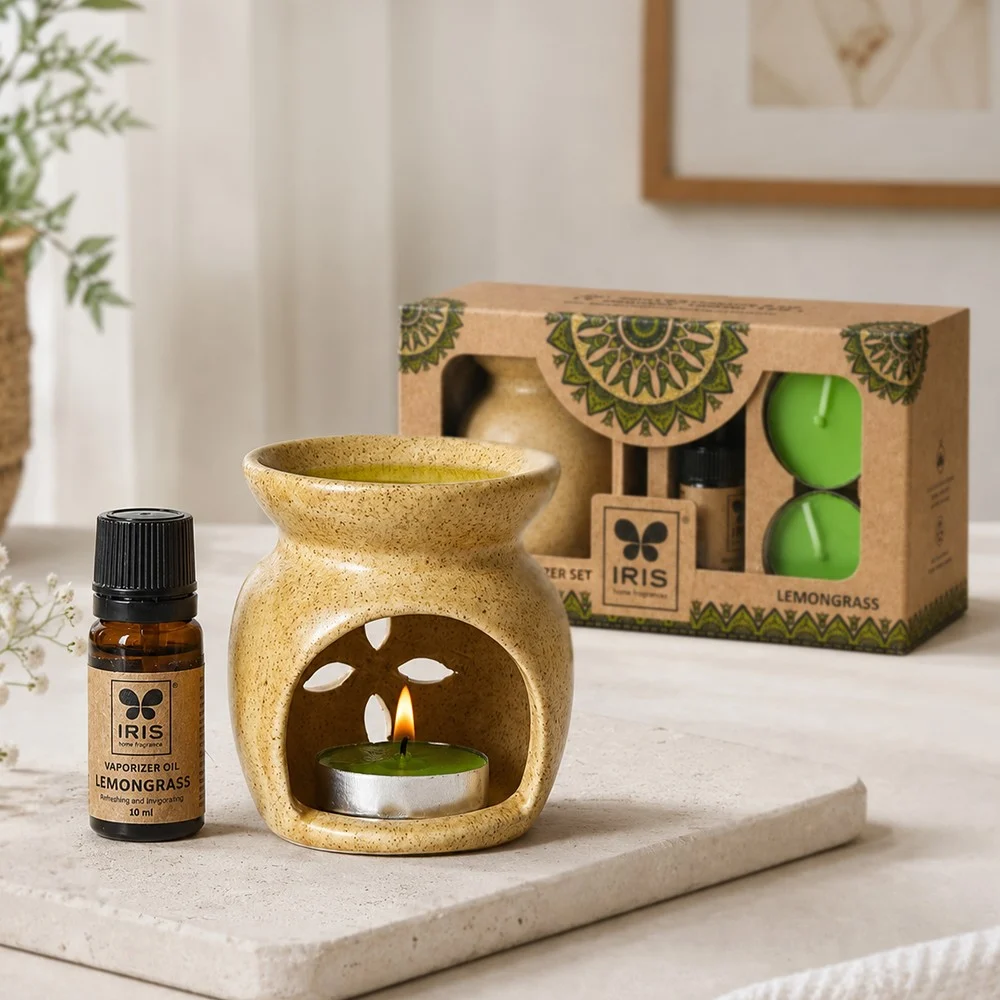 IRIS ceramic oil burner lit beside its fragrance oil and gift box