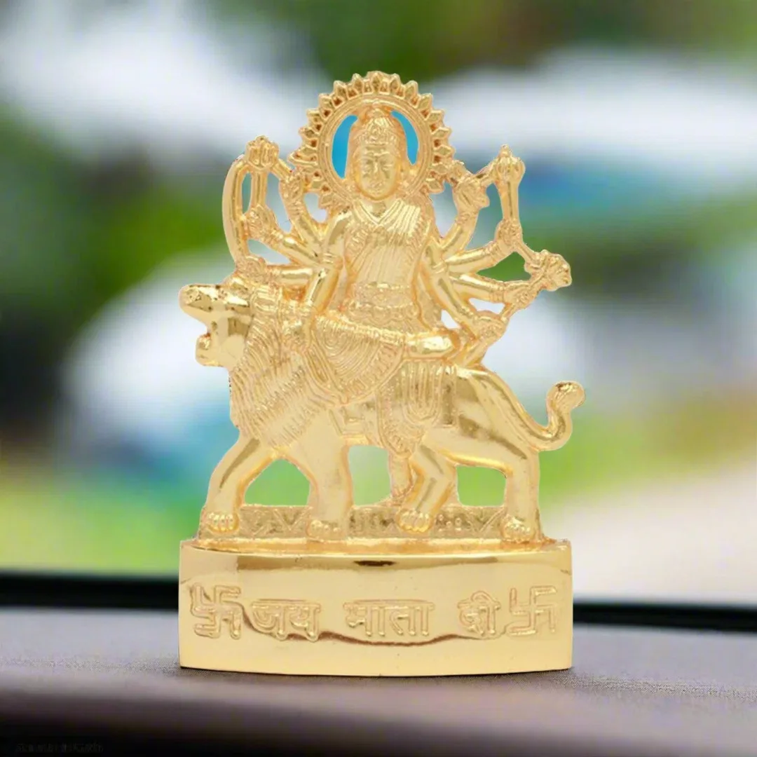 Golden Goddess Durga idol on a car dashboard